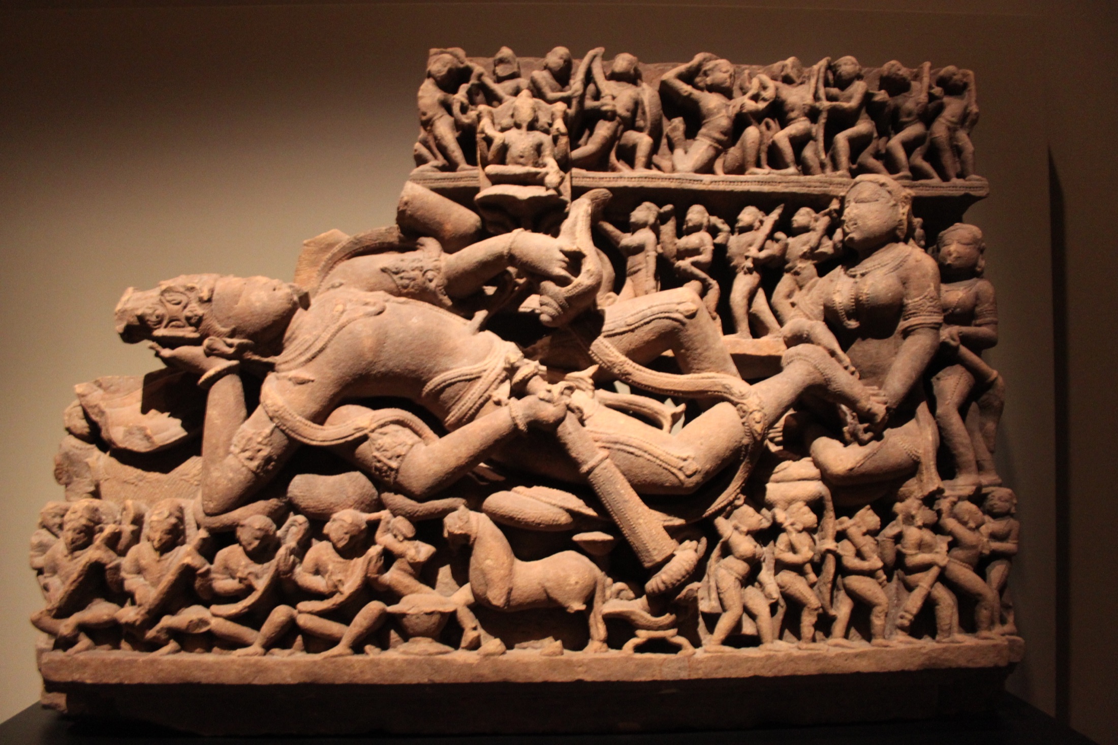 Photograph of an 11th-century sandstone sculpture of Lord Vishnu reclining on the cosmic ocean